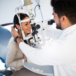Young woman having her eyes examined by optomtrist